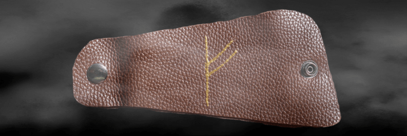 Fehu rune on the skin as a good luck charm